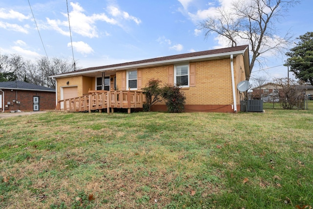 rear view of house featuring central AC unit and a yard