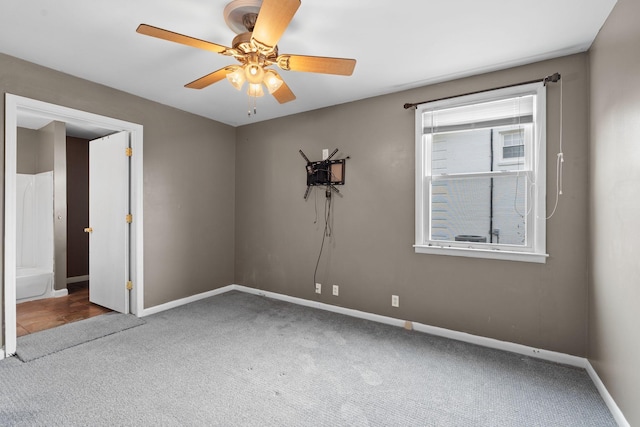 empty room with ceiling fan and carpet