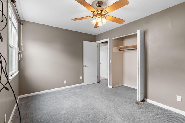 unfurnished bedroom featuring ceiling fan, a closet, and light carpet