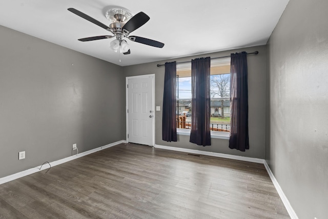 spare room featuring ceiling fan and hardwood / wood-style flooring