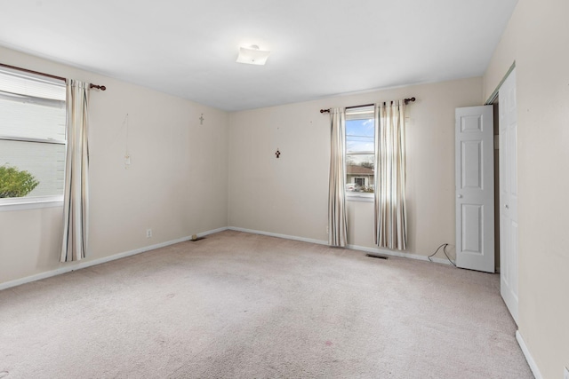 spare room with light carpet