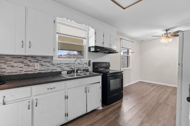 kitchen with backsplash, white cabinets, sink, black electric range, and dark hardwood / wood-style floors