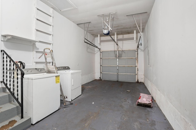 garage with washer and clothes dryer and a garage door opener