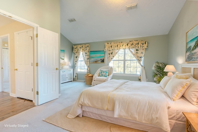 bedroom with carpet flooring and vaulted ceiling