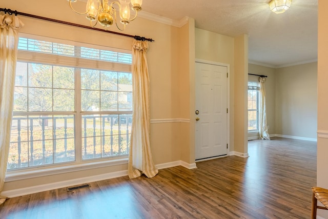 interior space featuring hardwood / wood-style floors, a wealth of natural light, and an inviting chandelier