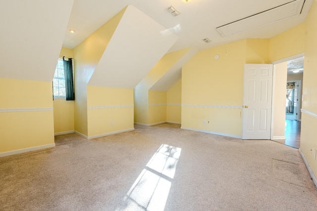 additional living space with light colored carpet and lofted ceiling