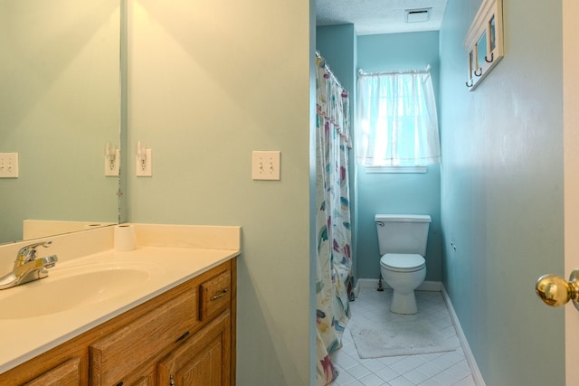 bathroom with vanity, tile patterned floors, a textured ceiling, and toilet