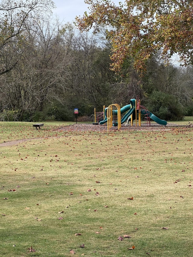 view of jungle gym featuring a lawn