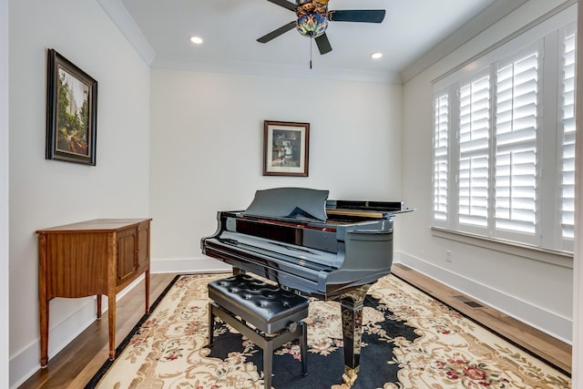 misc room featuring hardwood / wood-style floors, ceiling fan, and ornamental molding