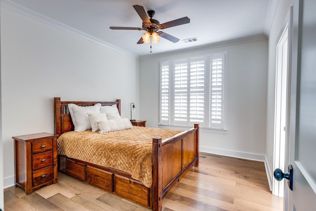 bedroom with light hardwood / wood-style flooring, ceiling fan, and crown molding