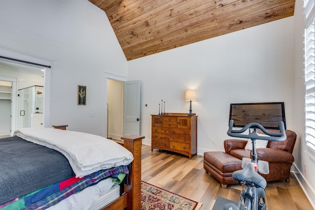 bedroom with light wood-type flooring and high vaulted ceiling