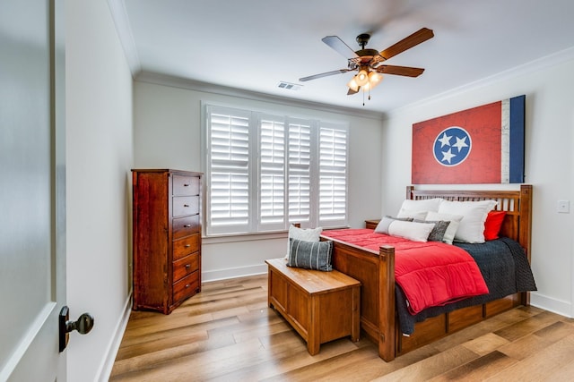 bedroom featuring light hardwood / wood-style floors, ceiling fan, and ornamental molding