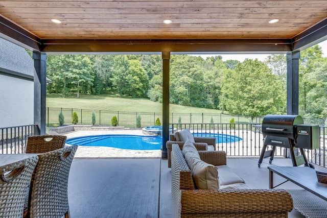 view of pool featuring a grill and a patio