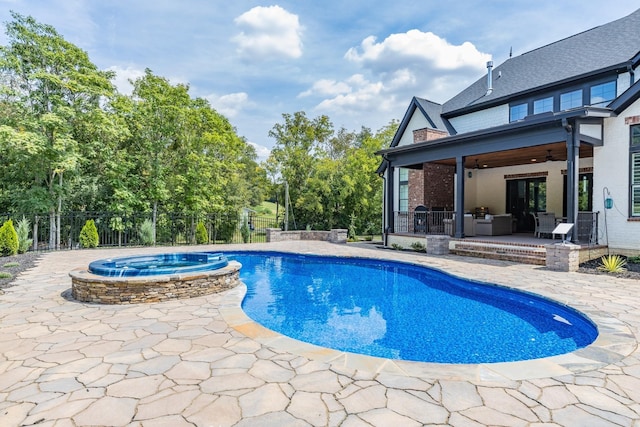 view of swimming pool featuring an in ground hot tub, ceiling fan, and a patio area