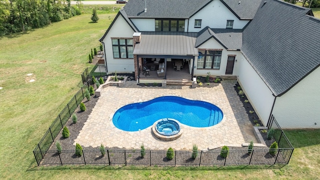 view of pool with a patio area, a yard, and an in ground hot tub