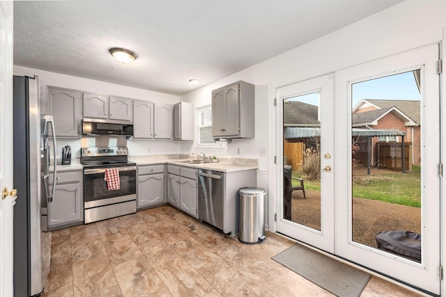 kitchen featuring french doors, sink, gray cabinetry, plenty of natural light, and appliances with stainless steel finishes