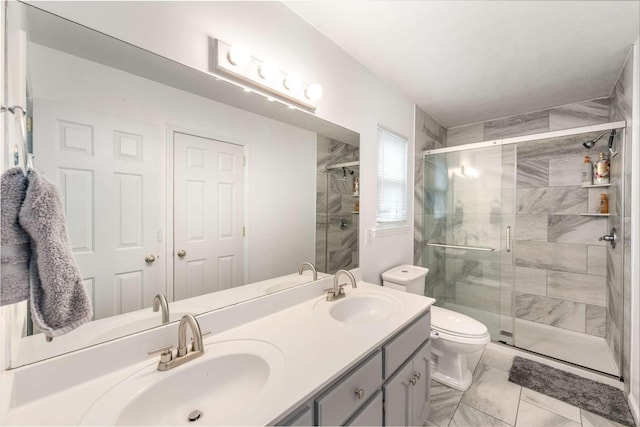 bathroom with walk in shower, vanity, and toilet