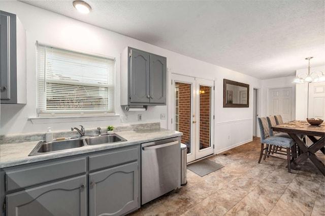 kitchen with sink, gray cabinets, dishwasher, an inviting chandelier, and hanging light fixtures