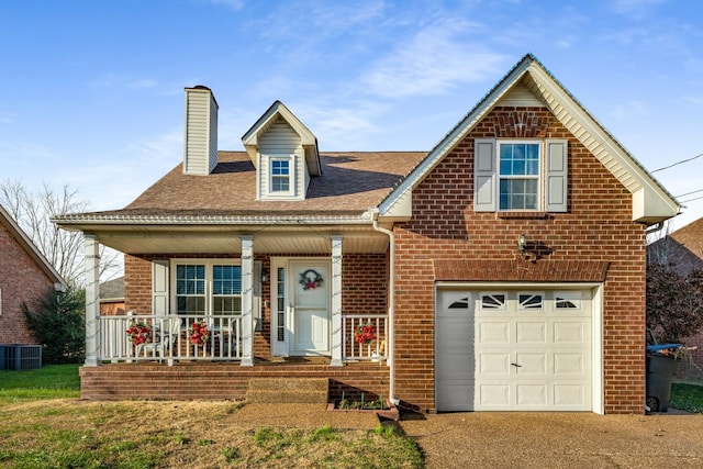 view of front of house featuring a garage, covered porch, and central air condition unit