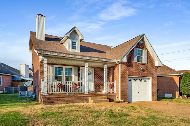 view of front of home with a porch, a garage, and a front yard