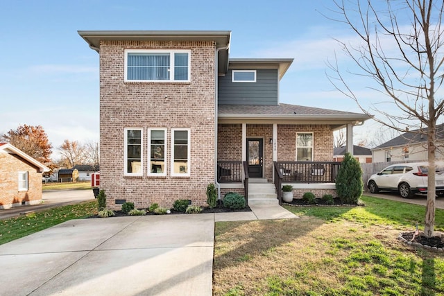 view of front of property featuring a porch and a front yard