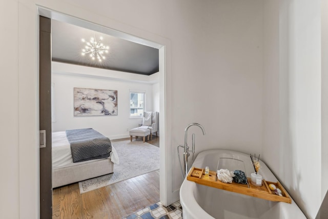 bedroom featuring hardwood / wood-style floors and a chandelier