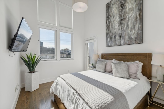 bedroom with dark hardwood / wood-style flooring