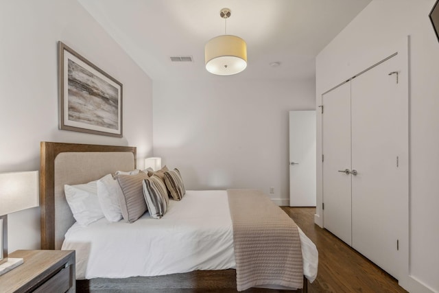 bedroom featuring a closet and dark wood-type flooring