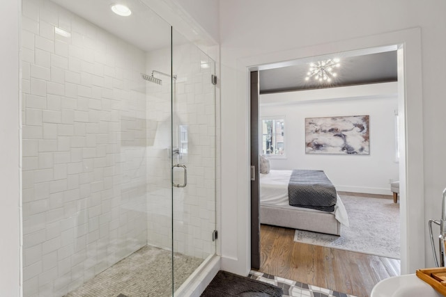 bathroom with hardwood / wood-style floors and walk in shower