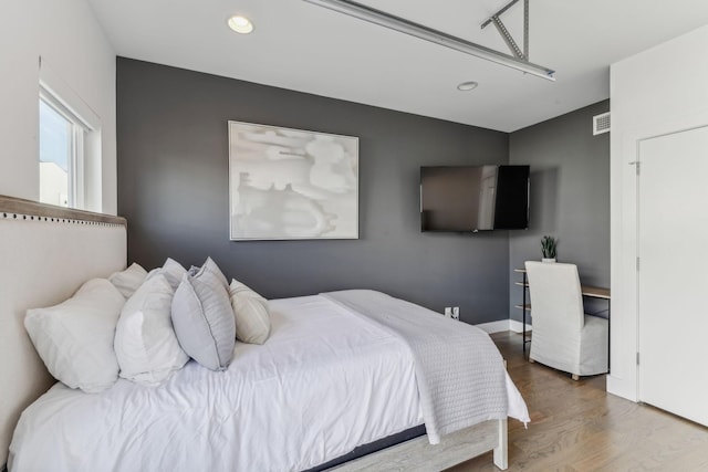 bedroom featuring hardwood / wood-style flooring