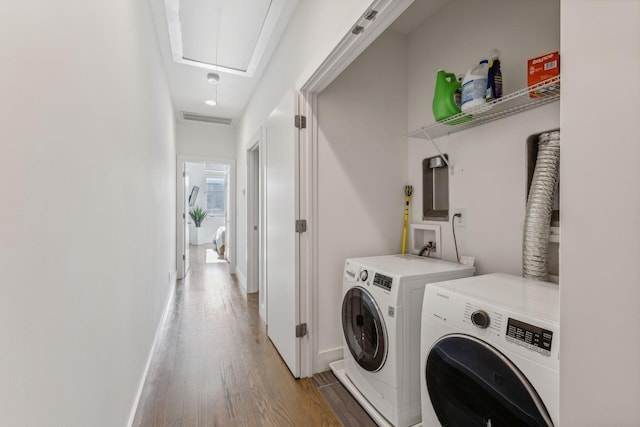 laundry area with wood-type flooring and independent washer and dryer