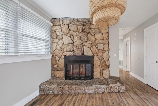 interior details featuring hardwood / wood-style flooring and a fireplace