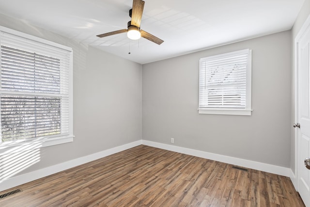 empty room with ceiling fan and hardwood / wood-style flooring