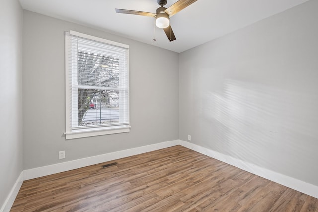 unfurnished room with ceiling fan and hardwood / wood-style floors