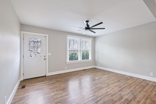 foyer with ceiling fan and wood-type flooring