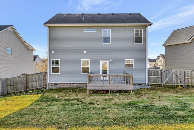 rear view of property featuring a lawn and a wooden deck