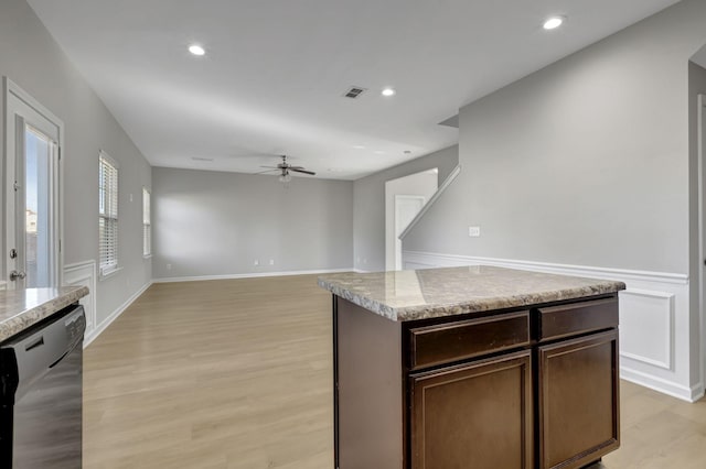 kitchen with dishwasher, a center island, ceiling fan, light hardwood / wood-style floors, and dark brown cabinetry