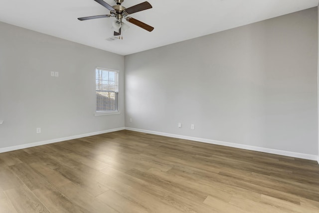 empty room with light wood-type flooring and ceiling fan