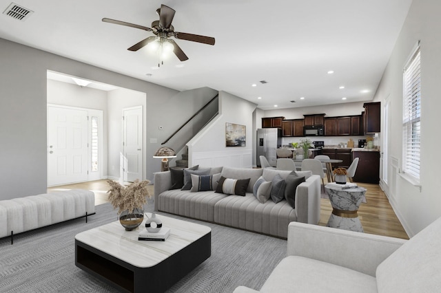 living room with ceiling fan and wood-type flooring