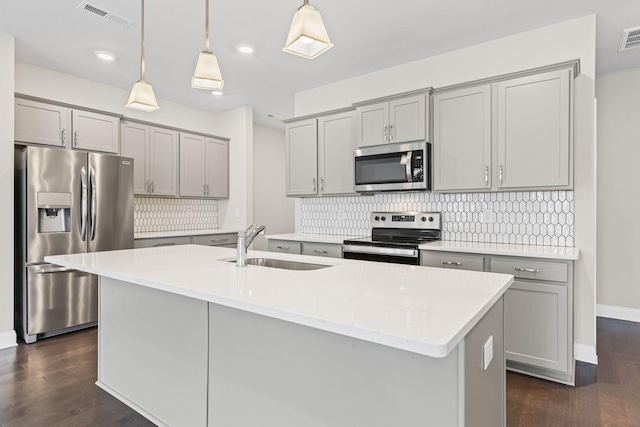 1249 June Wilde Rdg, Spring Hill, TN 37174 - kitchen featuring appliances with stainless steel finishes, gray cabinetry, dark wood-style floors, decorative backsplash, and recessed lighting