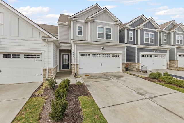 1249 June Wilde Rdg, Spring Hill, TN 37174 - view of front of property featuring stone siding, board and batten siding, driveway, and an attached garage