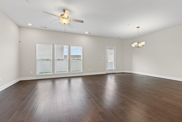 unfurnished room with dark hardwood / wood-style flooring and ceiling fan with notable chandelier