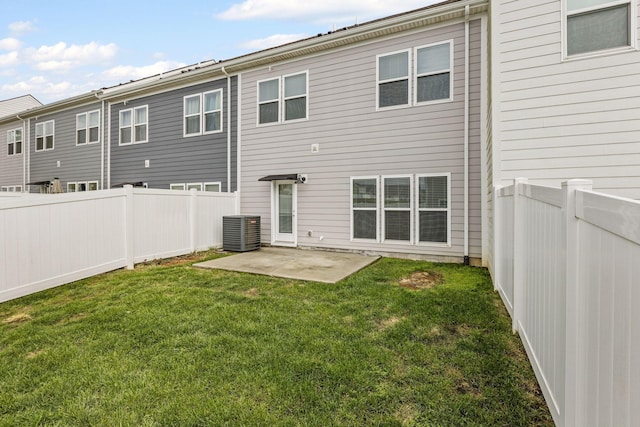 back of house with a lawn, central air condition unit, and a patio