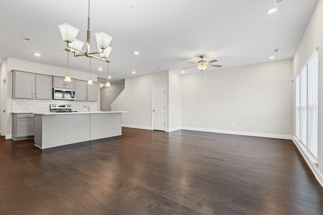 1249 June Wilde Rdg, Spring Hill, TN 37174 - kitchen featuring stainless steel microwave, gray cabinets, backsplash, recessed lighting, and light countertops