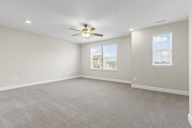 carpeted spare room with ceiling fan