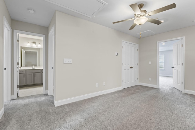 spare room with light carpet, sink, and ceiling fan