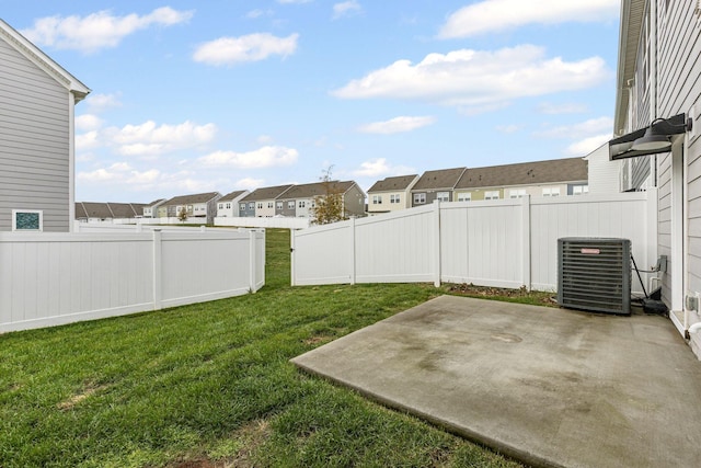 view of yard with cooling unit and a patio