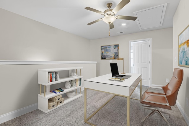 carpeted home office featuring ceiling fan