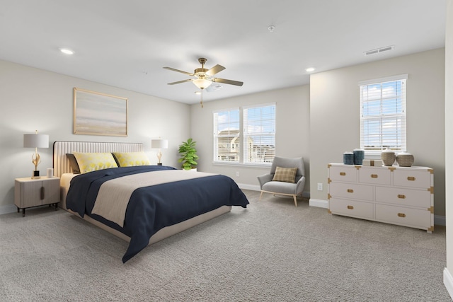 bedroom with ceiling fan and light carpet