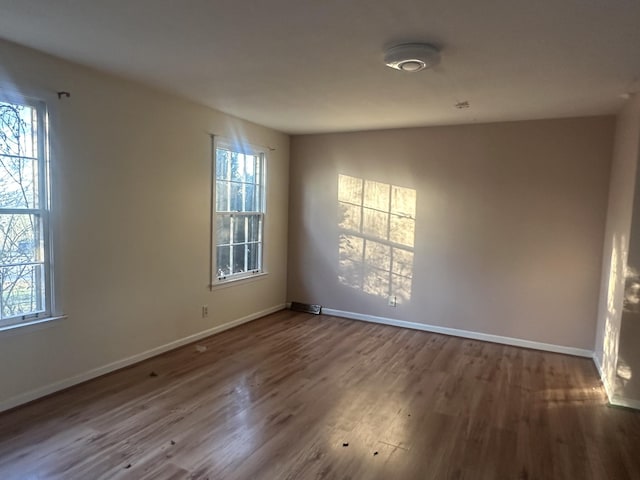 unfurnished room featuring hardwood / wood-style flooring